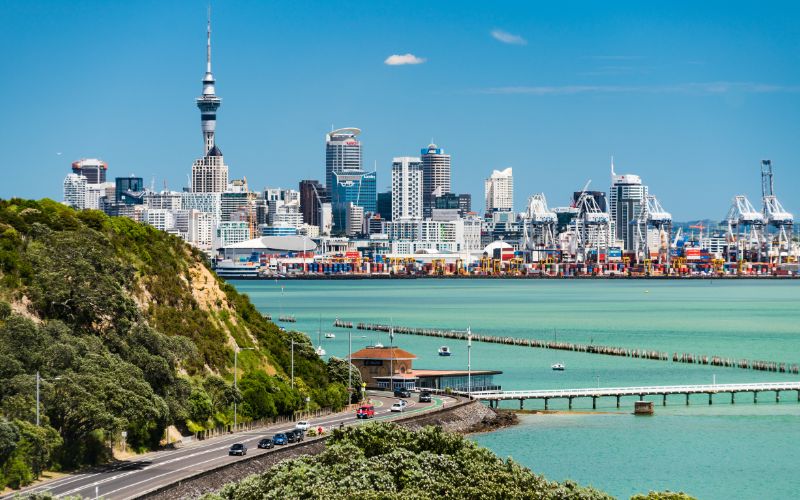 auckland city from far away showing sky tower and city skyline and harbour